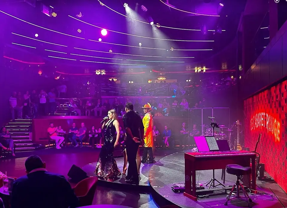 The Cabaret Rouge lounge aboard MSC Seashore, stage lit in purple with a red neon sign
